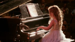 beautiful young girl playing the piano