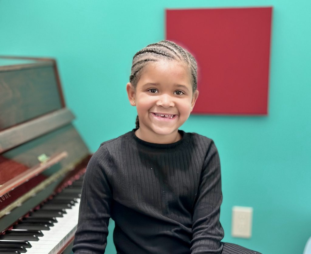 child practicing piano
